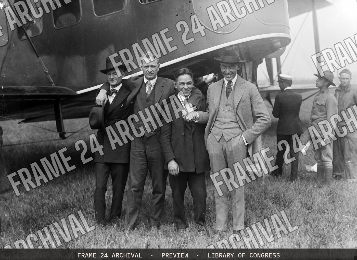 Group at airplane (1915), restored vintage black and white photograph