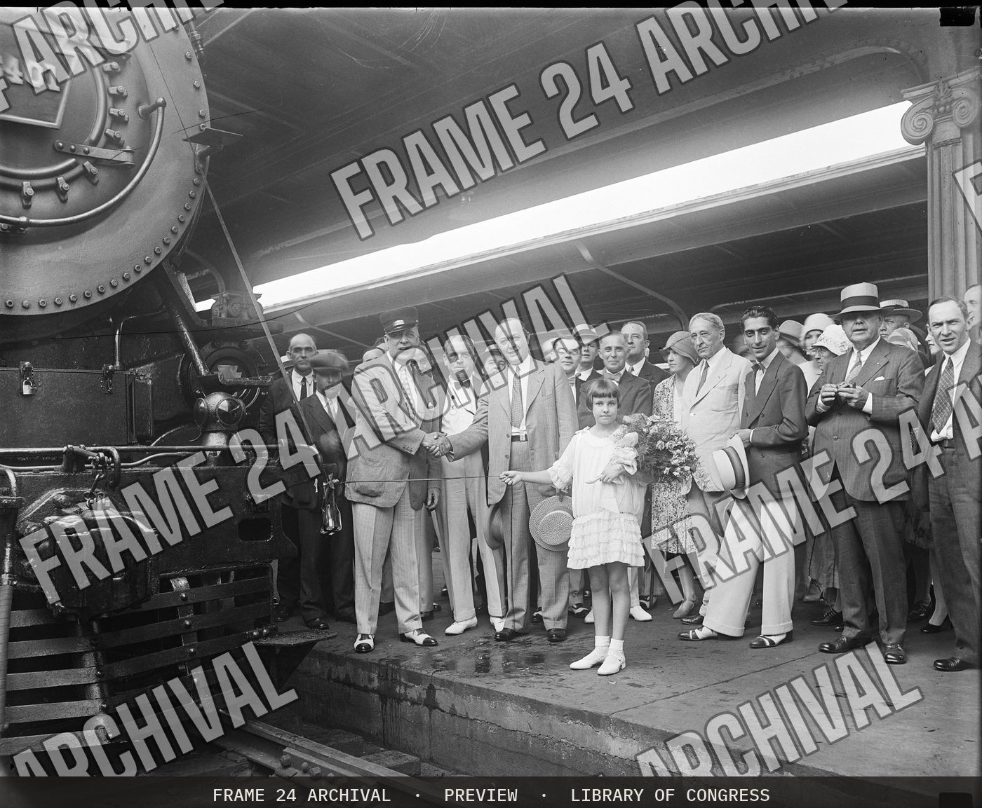 Group at train station (1929), restored vintage black and white photograph