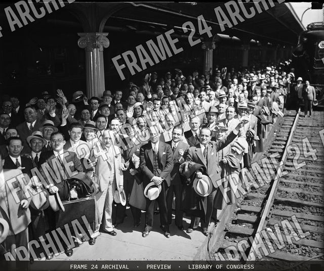 Group at train station, vintage black and white photograph