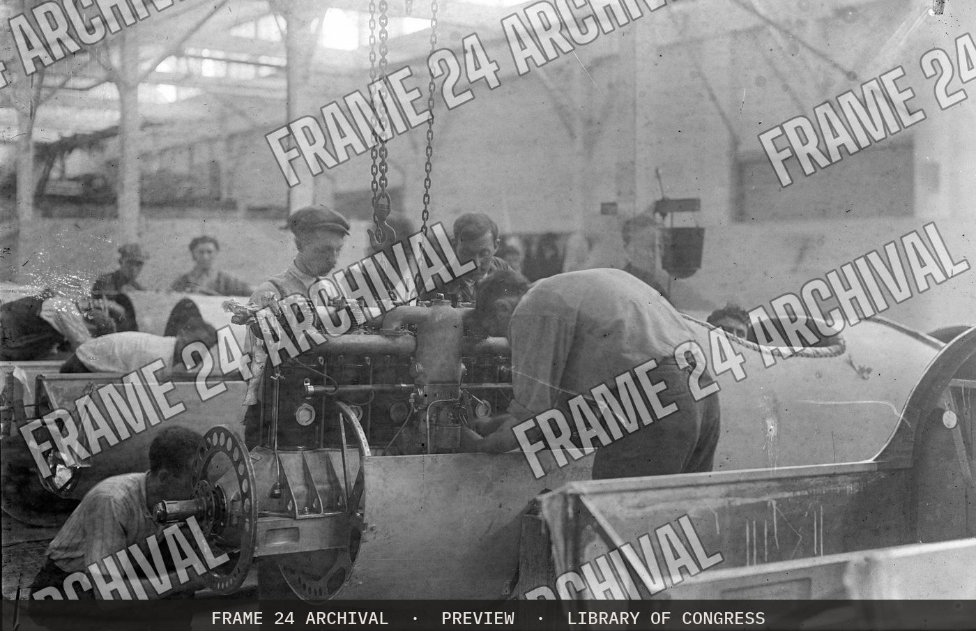 Installing aeroplane airplane engine (1915), restored vintage black and white photograph