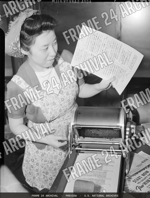 Los Angeles, California. Sadae Nomura, Associate Editor of the Los Angeles Daily News, is seen runn, vintage black and white photograph